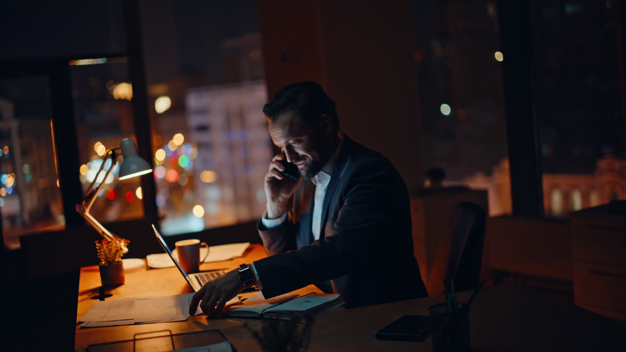 Professional employee smartphone call at evening company workspace. Man talking