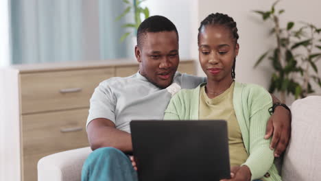 Love,-laptop-and-happy-couple-on-a-sofa