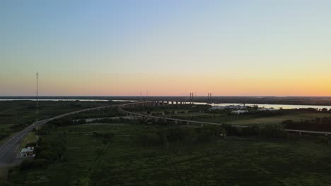 Aerial-dolly-right-of-Zarate-Brazo-Largo-bridge-on-the-distance-at-sunset