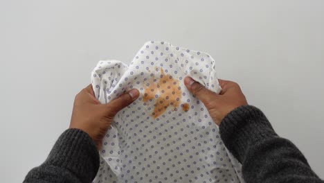 person holding a stained cloth