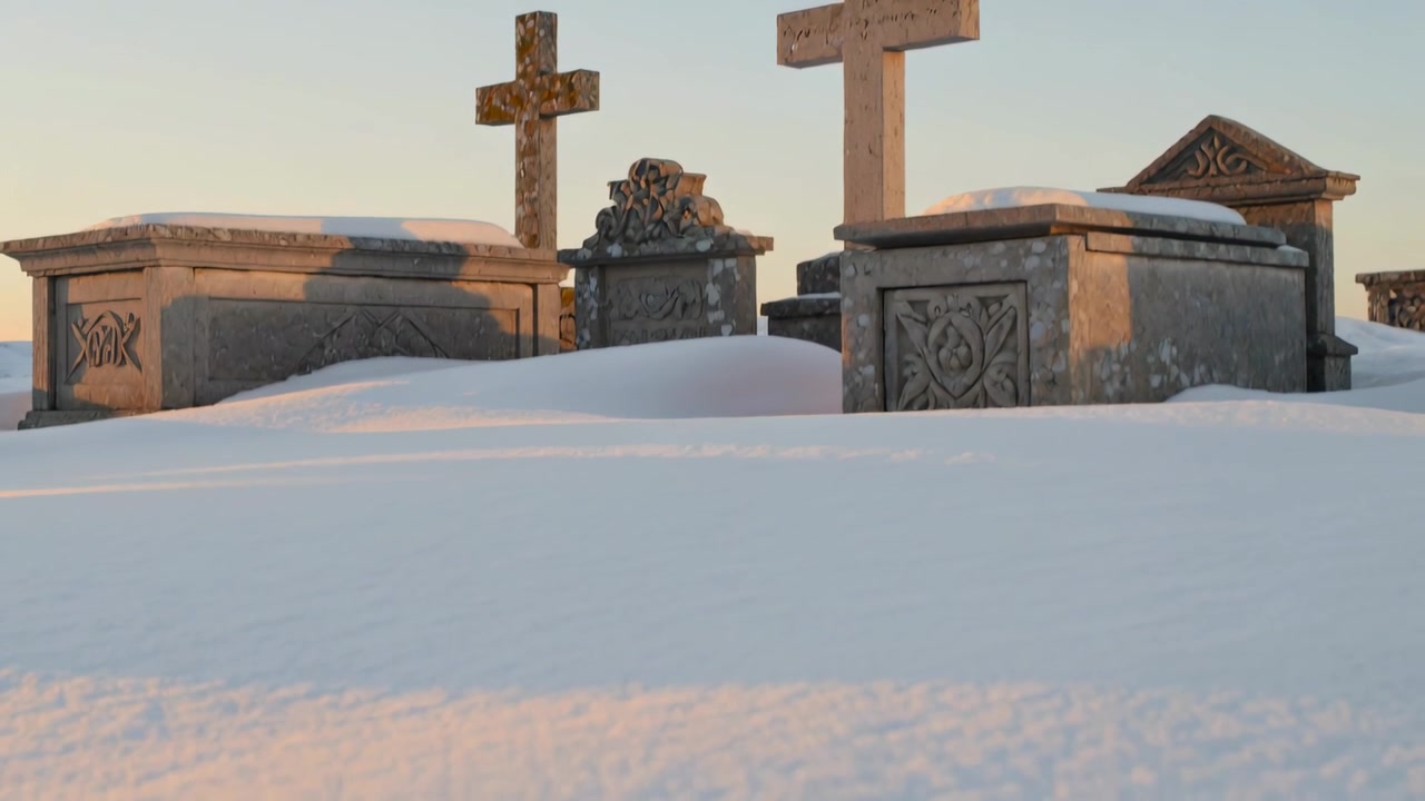 Moving camera revealing three stone tombs and two crosses in snowy cemetery, showing rising snow