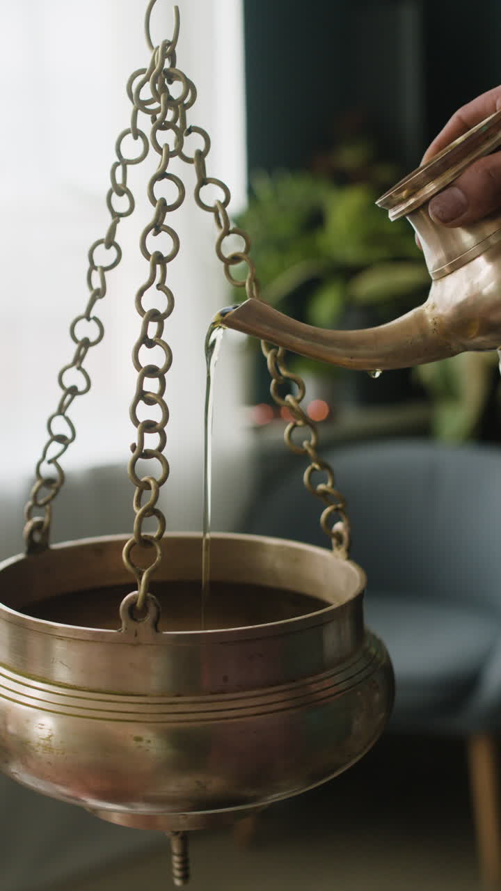 Water being poured into a hanging pot