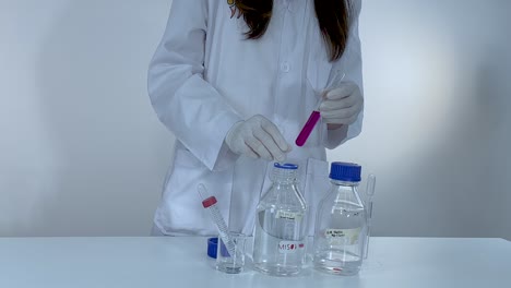 scientist demonstrates color change with phenolphthalein