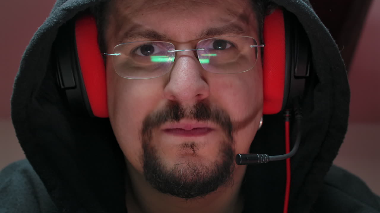 Closeup of a concentrated gamer with glasses playing online video games