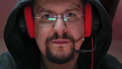 closeup of a concentrated gamer with glasses playing online video games