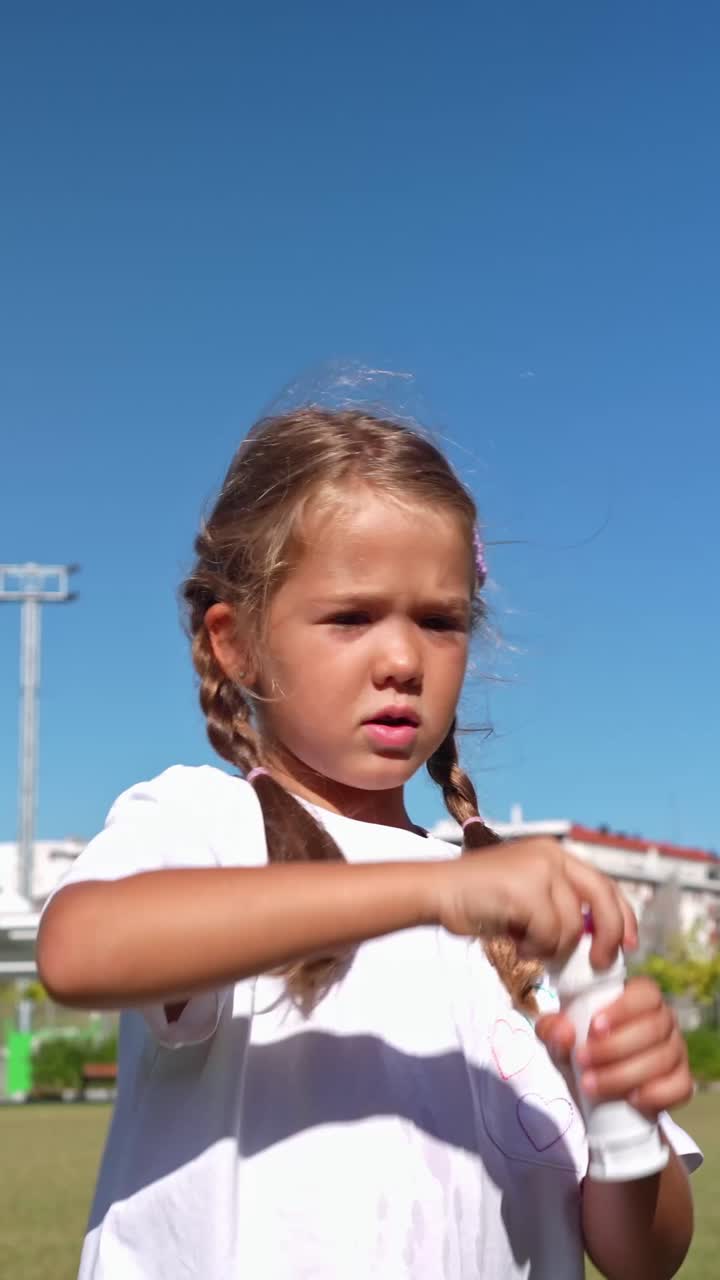 Girl Playing with Bubbles Outdoors