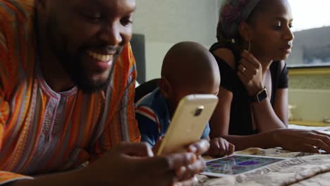 family using multimedia devices on bed in a comfortable home 4k