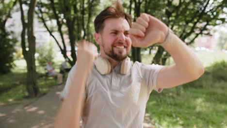 happy runner man jogging in city park looking at smartwatch checking result celebrating success