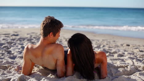 Couple-lying-on-the-sand