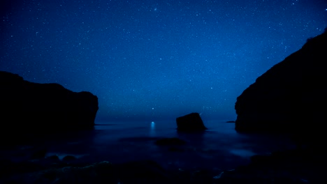 time-lapse. star trails above the rocky seashore