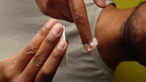 close up of man applying cream