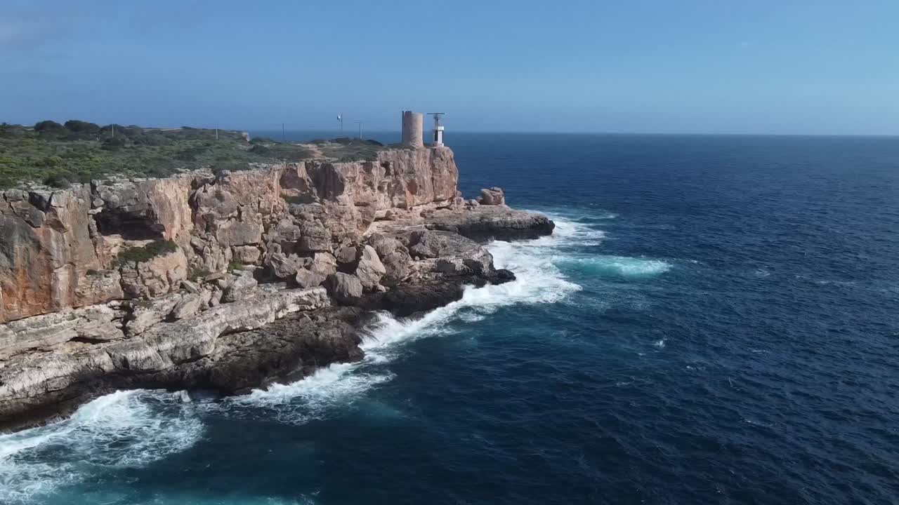 Torre d'en Beu lighthouse next to Cala Figuera on a sunny winter day, Mallorca, Spain