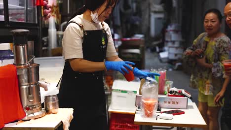 vendor serves juice to customers at market