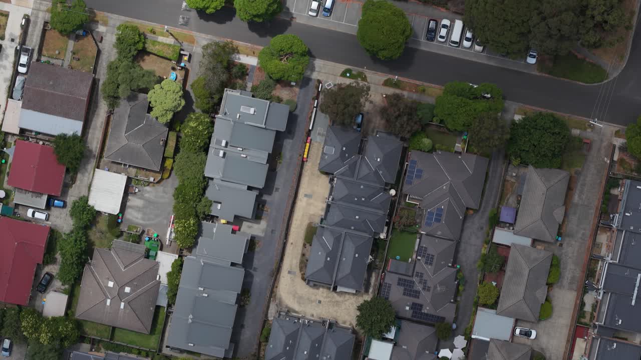 Drone footage capturing the structured layout of suburban homes in Boronia, Melbourne. Overhead view reveals vibrant rooftops, lush greenery, and residential architecture. Unique urban scene