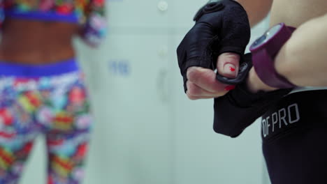 girl in dressing room at gym. back view of sport woman preparing for training in gym