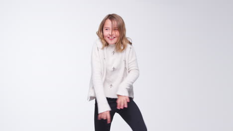 young girl dancing against white background in slow motion