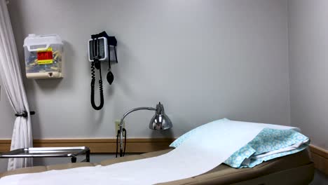 doctors office with an examination bed and a wall mounted medical tools