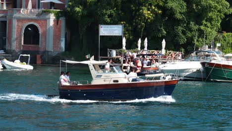 boat cruising past waterfront buildings and docks