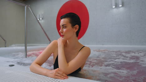 woman relaxing in a modern spa hot tub
