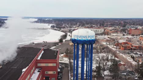 aerial, water tower in stevens point wisconsin during winter day