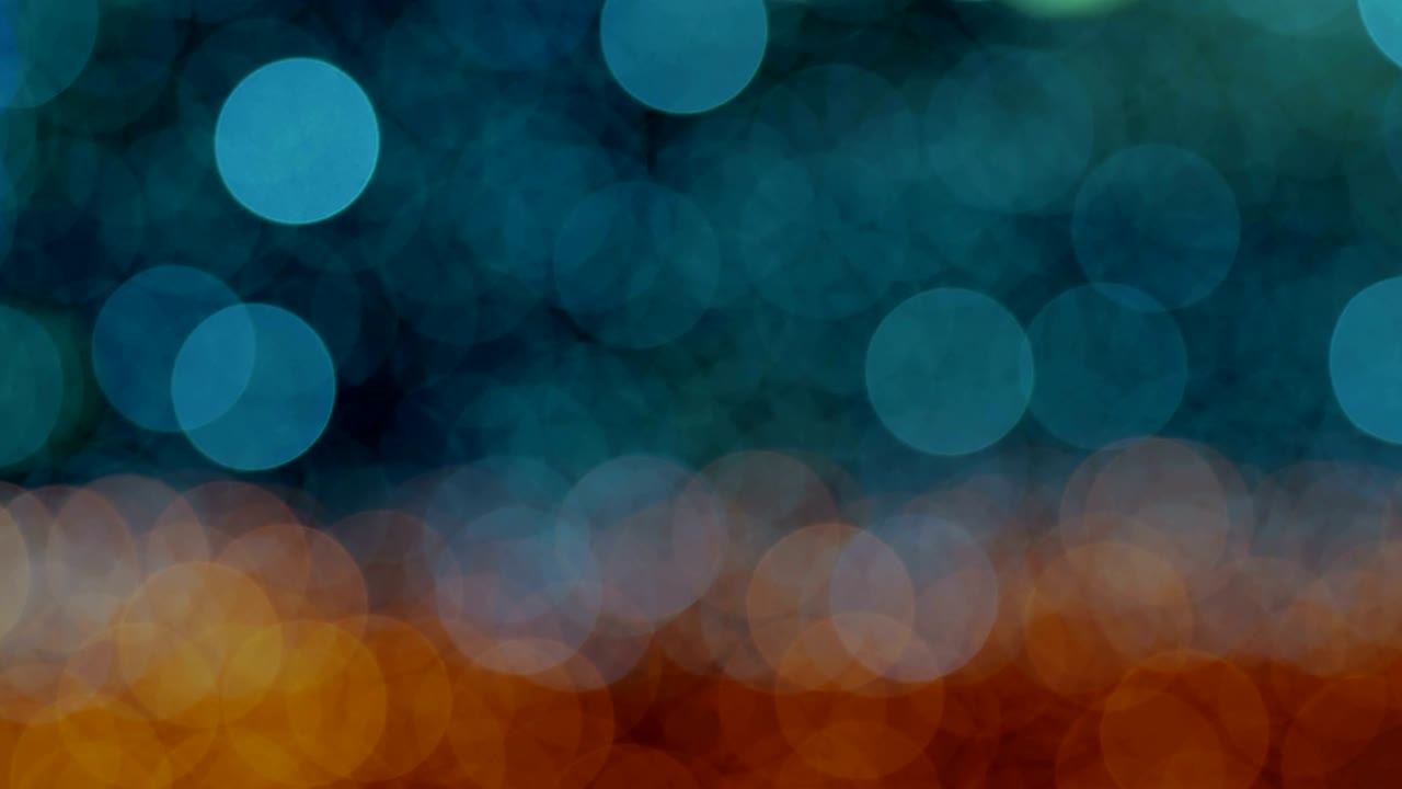 Night abstract background is defocused with nice bokeh. Blurred Christmas Lights Bokeh. Pan across blur .