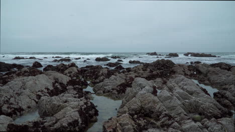 beautiful overcast rocky beach and waves in monterey california 4k