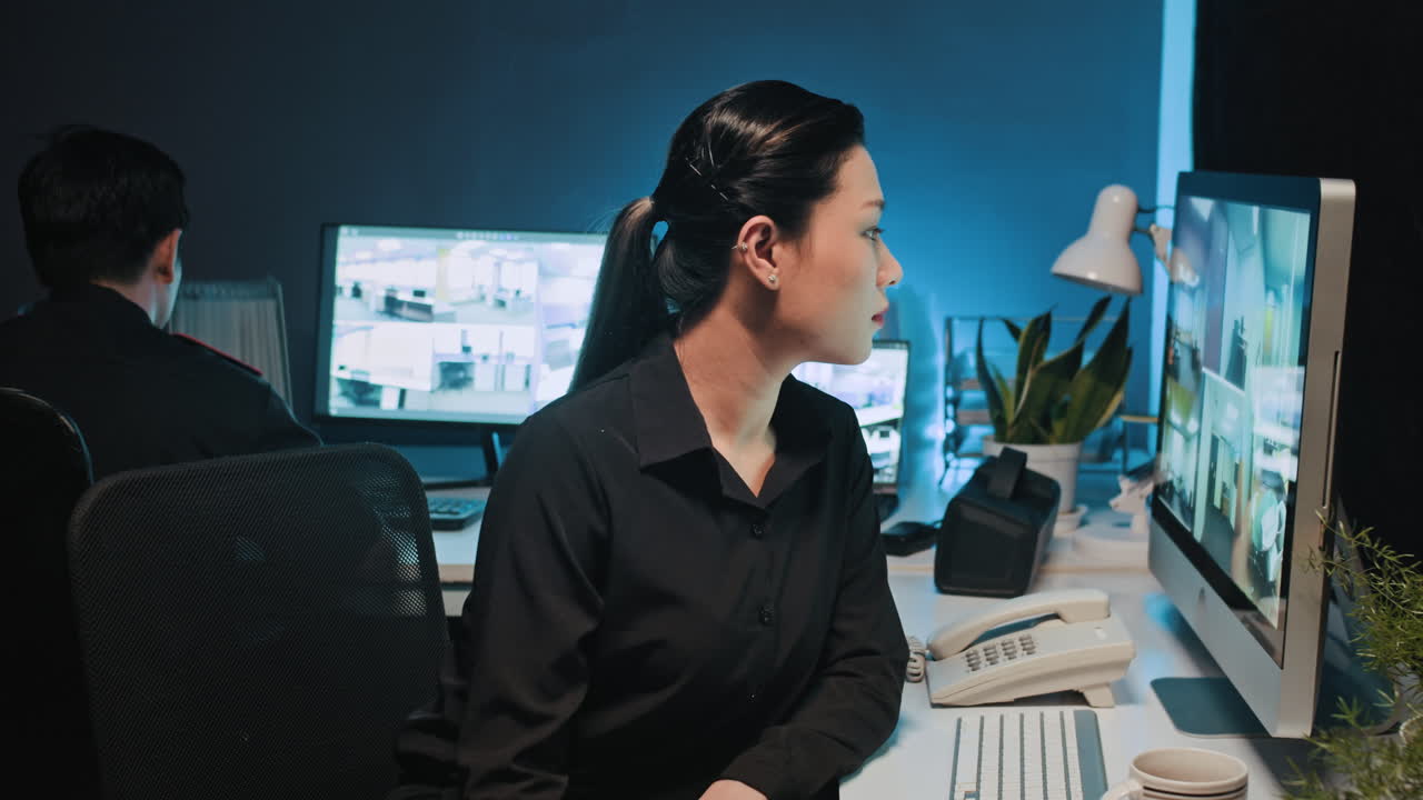 Portrait of Female Security Manager Checking CCTV Cameras
