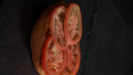 tomato falling on a burger bun in slow motion