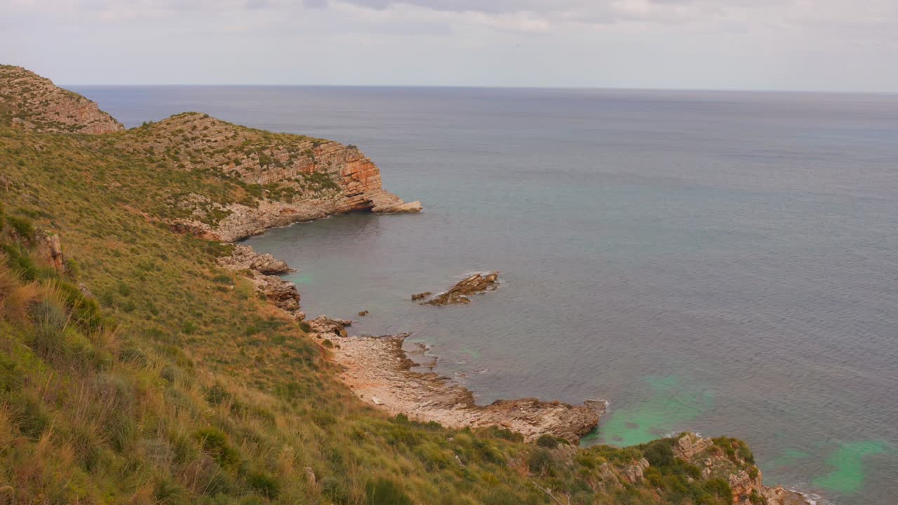 Beautiful coastal landscape of Sicily with rocky shoreline and clear blue water