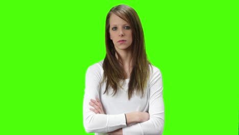 young brown blonde woman with arms crossed looking neutral at the camera