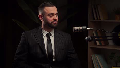 businessman in a suit giving a podcast interview
