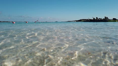 paddle boat kayak in shallow water of tropical island paradise with sunlight on ocean surface and white sand underwater