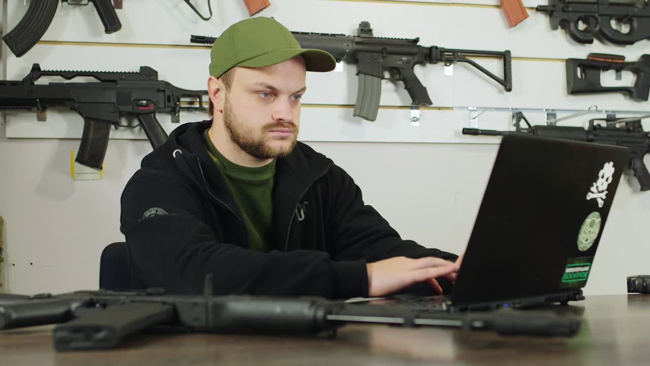 Man behind a counter in an arms store 4