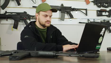 man behind a counter in an arms store 4