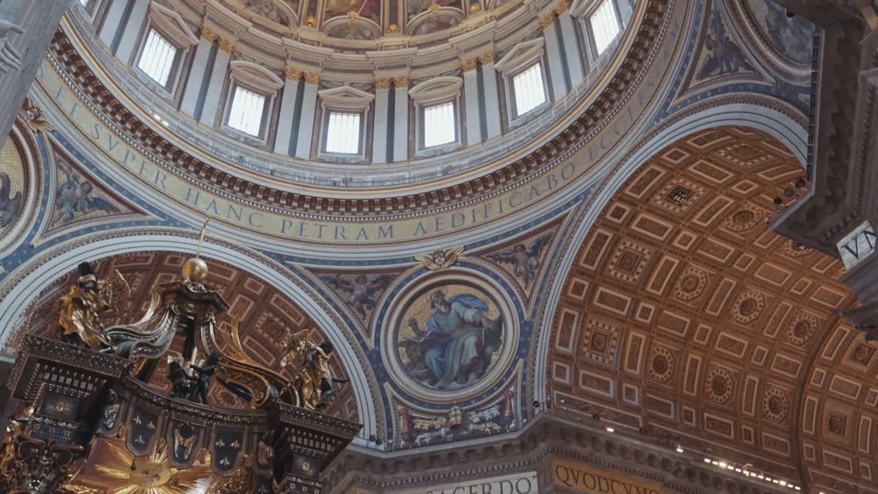 Panning up interior view of St. Peter’s Basilica focuses on the towering dome and decorated ceiling, capturing the essence of Rome’s most iconic religious landmark