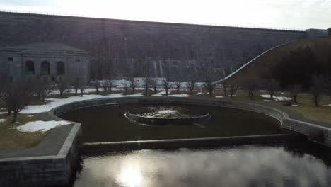 drone shot near the bubbling fountain at base of the wachusett reservoir dam