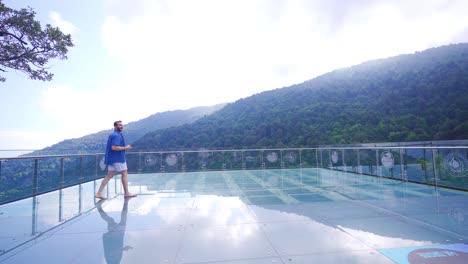 man walking on canyon glass terrace.