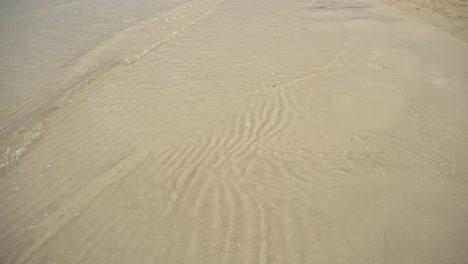 ocean waves calmly glide through the sand 4k uhd