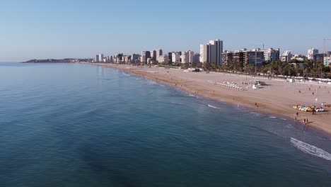 Flying-backwards-from-the-beautiful-San-Juan-Beach,-in-Alicante,-Spain