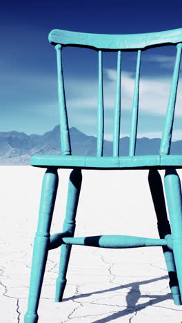 a blue chair in the desert