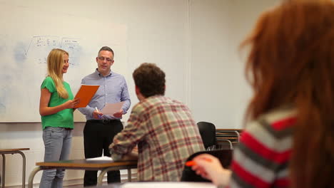 blonde student giving a presentation to his class