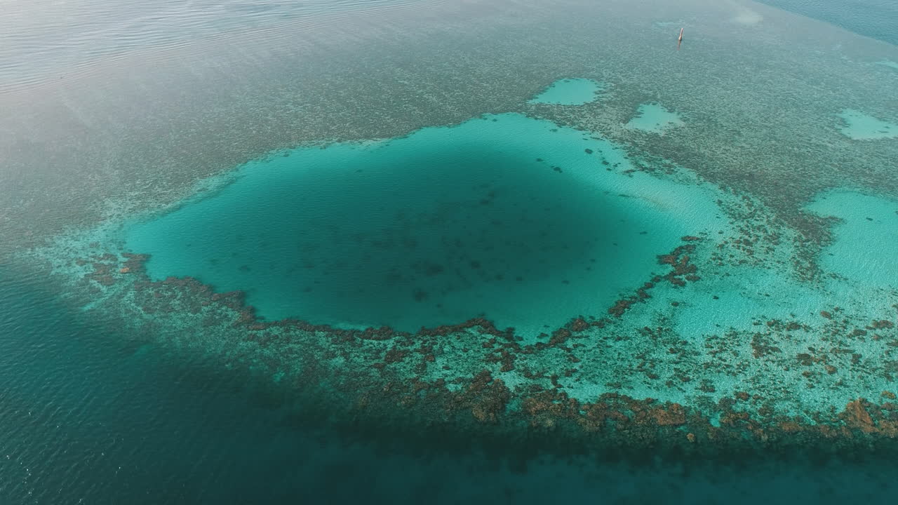 Aerial Shot for the Diving Site Abu Nuhas Coral Island in Red Sea of Egypt in the North beside Hurghada with the drone moving forward towards a light house on a coral island of Abu Nuhas Coral island