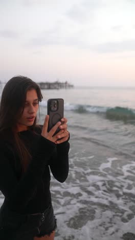 woman taking photo at the beach