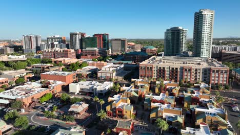 tempe, arizona skyline: modern skyscrapers, colorful housing, palm trees, with distant mountains