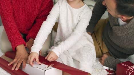 Handheld-view-of-family-packing-Christmas-gifts