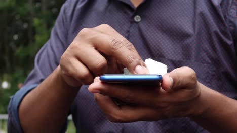 man hand cleaning mobile phone display