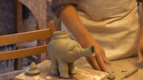 potter working on clay sculpture