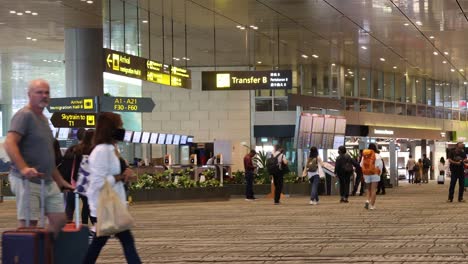 passengers walking and waiting in airport terminal