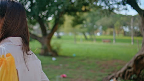 relaxed eco volunteer holding waste bag in park. portrait woman after cleanup