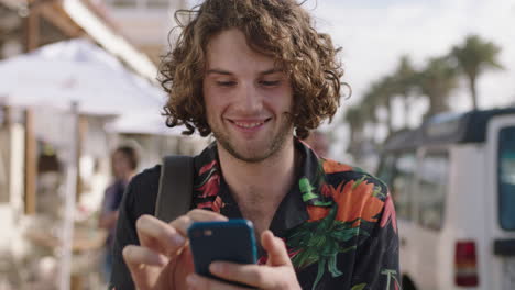 portrait of young attractive man using phone enjoying vacation wearing hawaiian shirt